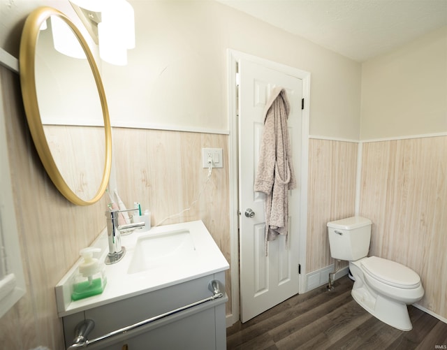 1014 W 7th St, Mishawaka, IN 46544 - bathroom featuring a wainscoted wall, vanity, toilet, and wood finished floors
