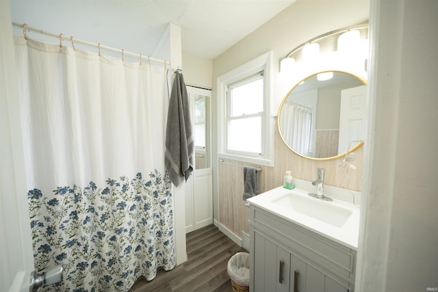 1014 W 7th St, Mishawaka, IN 46544 - full bathroom featuring vanity, wood finished floors, wainscoting, and a shower with shower curtain