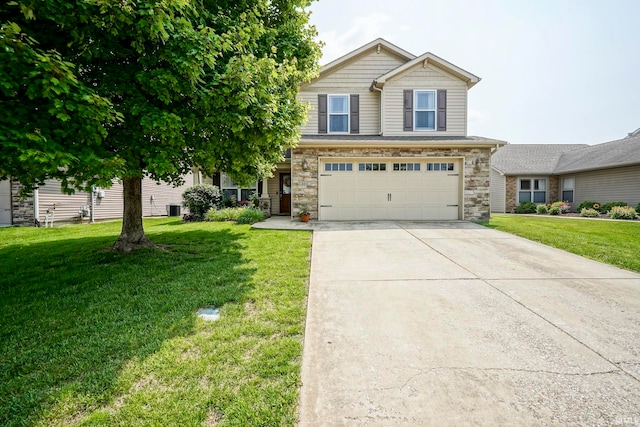 460 Kettle Cir, Lafayette, IN 47905 - view of front of home featuring driveway, a garage, a front yard, and stone siding