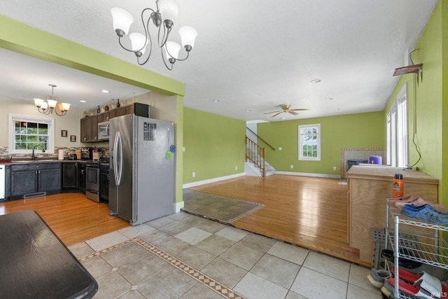 2890 W 400 N, Columbia City, IN 46725 - kitchen with a chandelier, stainless steel appliances, open floor plan, dark countertops, and light tile patterned floors