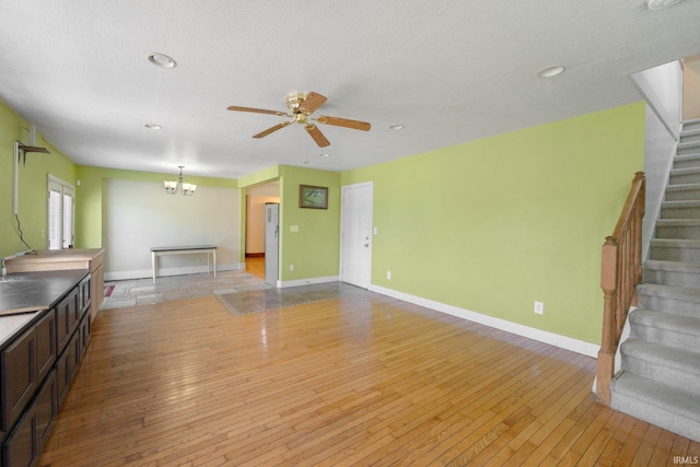 2890 W 400 N, Columbia City, IN 46725 - unfurnished living room featuring stairway, light wood finished floors, a chandelier, ceiling fan, and recessed lighting