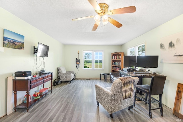 2890 W 400 N, Columbia City, IN 46725 - living area featuring wood finished floors, a ceiling fan, and a textured ceiling