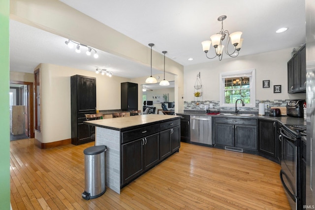 2890 W 400 N, Columbia City, IN 46725 - kitchen with appliances with stainless steel finishes, dark cabinets, light wood finished floors, a kitchen island, and recessed lighting