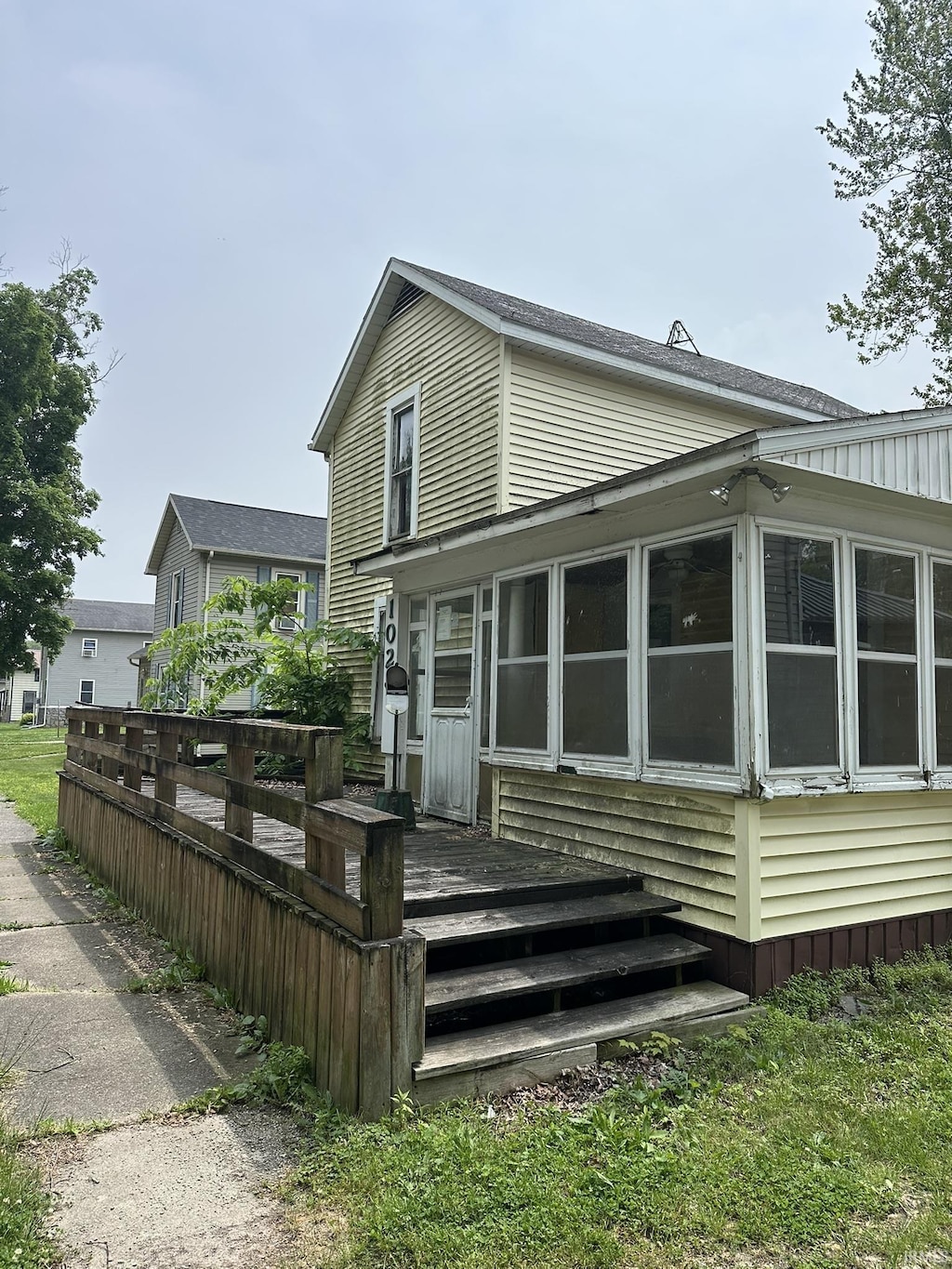 102 E County Line Rd, St, Wolcottville, IN 46795 - back of house with a sunroom and a wooden deck