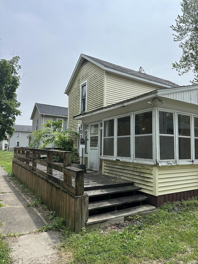 102 E County Line Rd, St, Wolcottville, IN 46795 - back of house with a sunroom and a wooden deck