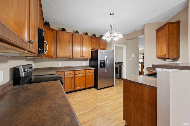 2729 Massasoit Ln, Lafayette, IN 47909 - kitchen with appliances with stainless steel finishes, dark countertops, light wood finished floors, a chandelier, and brown cabinets