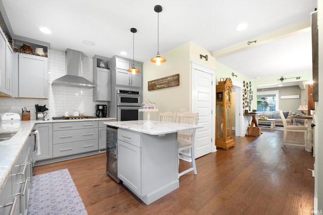 1214 W Jefferson Blvd, Fort Wayne, IN 46802 - kitchen featuring wall chimney range hood, gray cabinets, double oven, gas cooktop, and tasteful backsplash