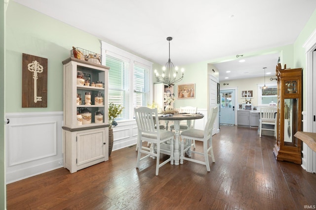 1214 W Jefferson Blvd, Fort Wayne, IN 46802 - dining space featuring a wainscoted wall, dark wood-type flooring, a chandelier, and a decorative wall