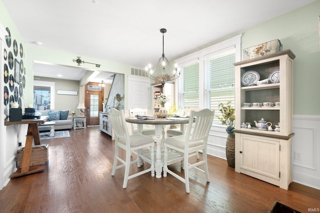 1214 W Jefferson Blvd, Fort Wayne, IN 46802 - dining area with a chandelier, dark wood finished floors, a wainscoted wall, and a decorative wall