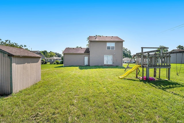 1817 N Elmer St, South Bend, IN 46628 - view of green lawn featuring a playground and an outbuilding