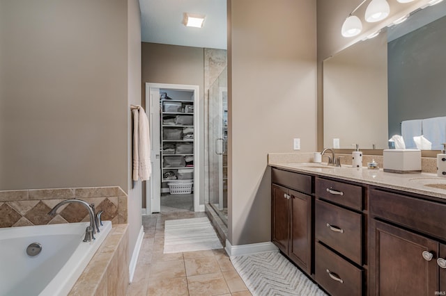 319 Pistoia Cv, Fort Wayne, IN 46845 - bathroom with double vanity, a garden tub, a stall shower, and a spacious closet