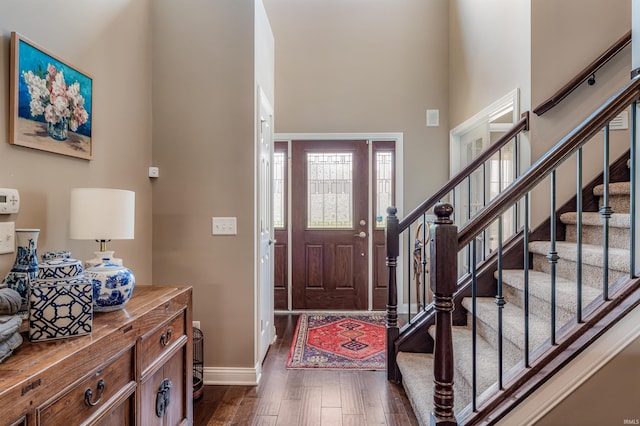 319 Pistoia Cv, Fort Wayne, IN 46845 - entrance foyer featuring a high ceiling, dark wood finished floors, and stairs