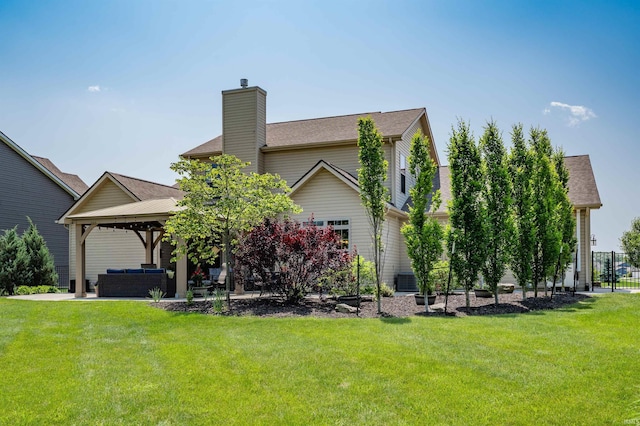 319 Pistoia Cv, Fort Wayne, IN 46845 - back of property featuring a gazebo, an outdoor living space, a chimney, and a yard