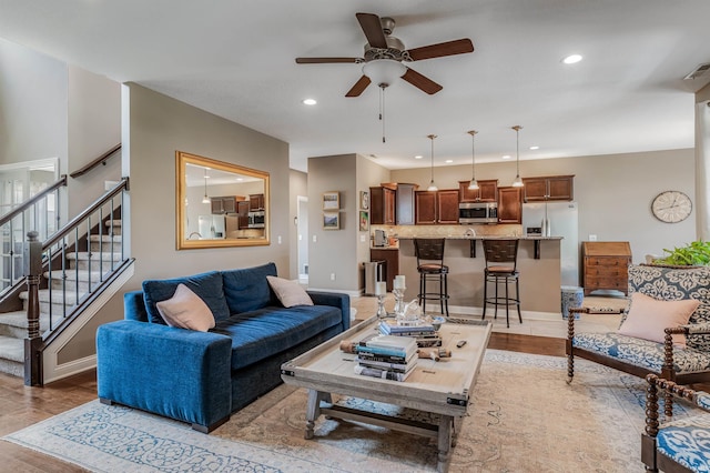 319 Pistoia Cv, Fort Wayne, IN 46845 - living room with a ceiling fan, recessed lighting, stairway, and light wood finished floors