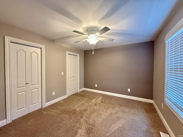 9820 Arbor Lake Dr, Newburgh, IN 47630 - unfurnished bedroom with multiple closets, carpet flooring, and ceiling fan