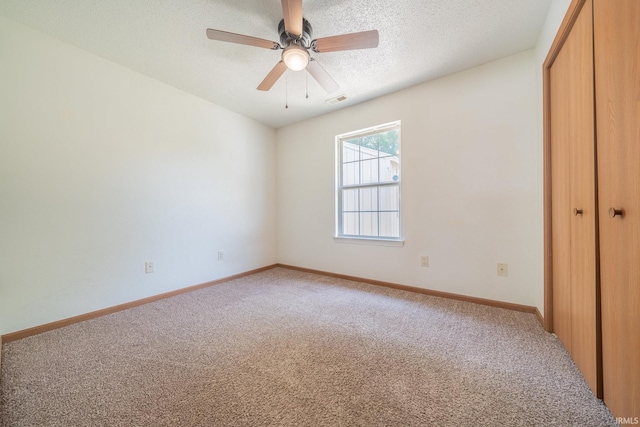 2645 Wynterpointe Ct, Kokomo, IN 46901 - unfurnished bedroom with a closet, light colored carpet, a textured ceiling, and a ceiling fan