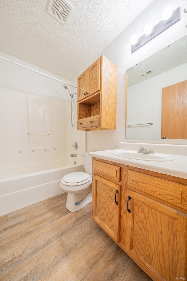 2645 Wynterpointe Ct, Kokomo, IN 46901 - bathroom featuring vanity, wood finished floors,  shower combination, and a textured ceiling