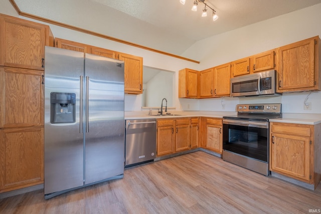 2645 Wynterpointe Ct, Kokomo, IN 46901 - kitchen with stainless steel appliances, lofted ceiling, light wood finished floors, light countertops, and brown cabinets