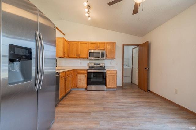 2645 Wynterpointe Ct, Kokomo, IN 46901 - kitchen with stainless steel appliances, washer / dryer, lofted ceiling, light countertops, and ceiling fan
