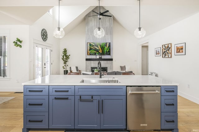 4331 S Windmill Ln, Bloomington, IN 47401 - kitchen featuring stainless steel dishwasher, light wood-style floors, pendant lighting, light countertops, and high vaulted ceiling
