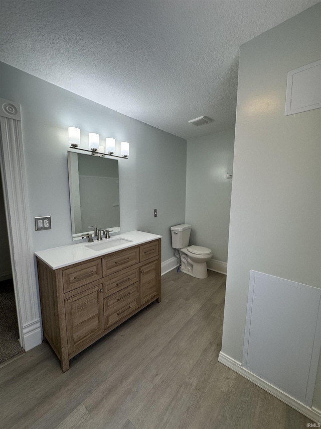 241 W Tipton St, Huntington, IN 46750 - bathroom with wood finished floors, vanity, and a textured ceiling