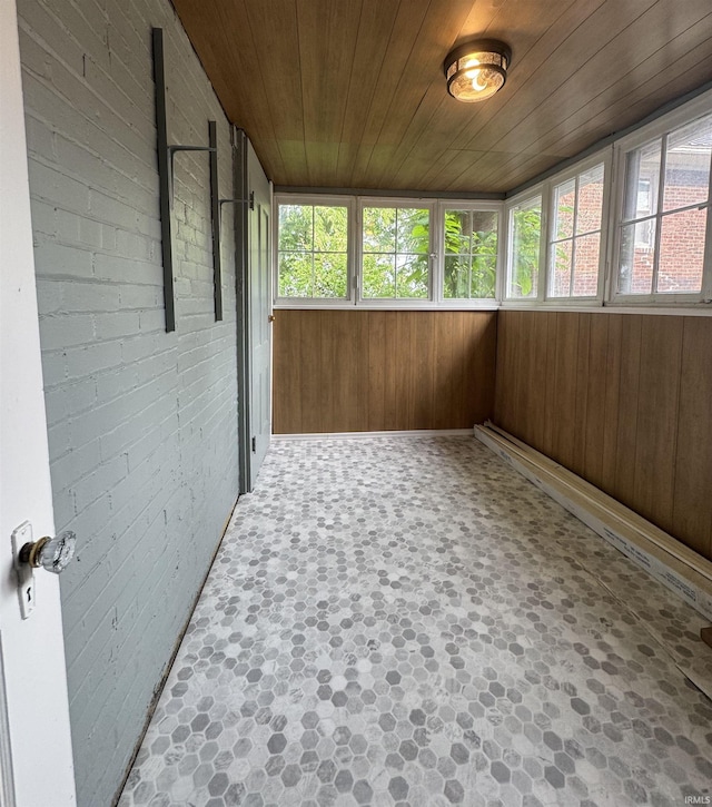 241 W Tipton St, Huntington, IN 46750 - unfurnished sunroom with healthy amount of natural light, wood ceiling, wooden walls, and brick wall