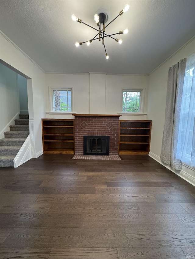 241 W Tipton St, Huntington, IN 46750 - unfurnished living room with a chandelier, plenty of natural light, dark wood-type flooring, crown molding, and a textured ceiling