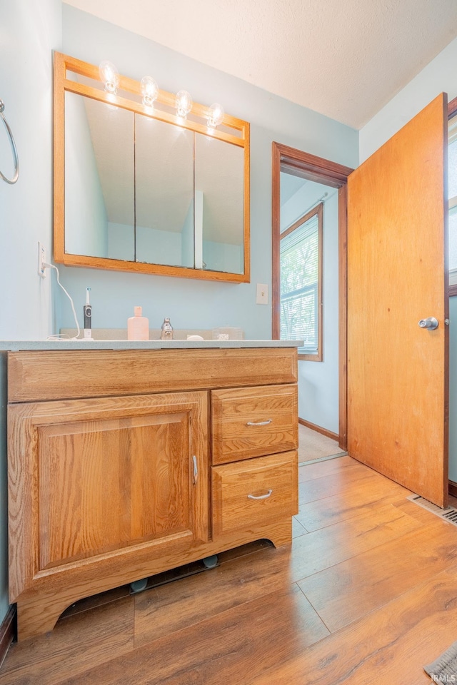 602 S Maple St, Galveston, IN 46932 - bathroom featuring wood finished floors and vanity
