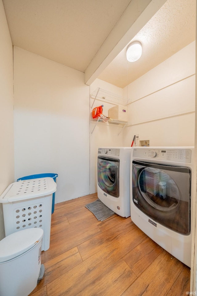 602 S Maple St, Galveston, IN 46932 - washroom with light wood-style flooring and washing machine and clothes dryer