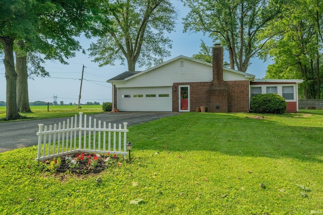 602 S Maple St, Galveston, IN 46932 - ranch-style home featuring an attached garage, driveway, brick siding, and a chimney