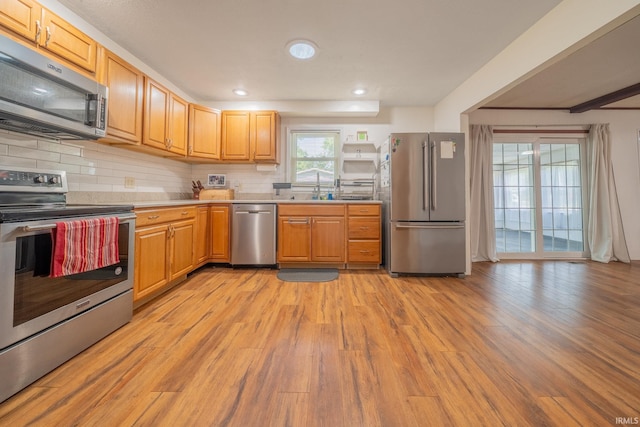 602 S Maple St, Galveston, IN 46932 - kitchen featuring stainless steel appliances, light wood finished floors, tasteful backsplash, and recessed lighting