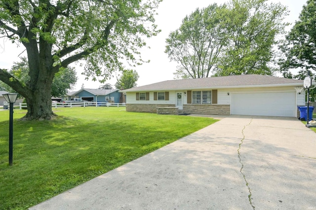 708 Carson Ct, Kokomo, IN 46902 - ranch-style home featuring a garage, driveway, and stone siding