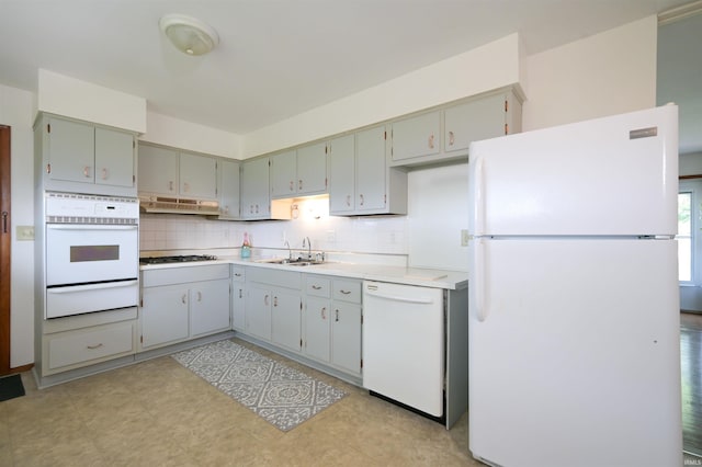 708 Carson Ct, Kokomo, IN 46902 - kitchen with white appliances, a warming drawer, under cabinet range hood, tasteful backsplash, and light countertops