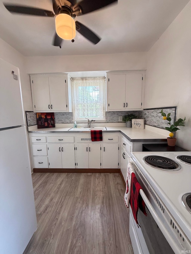 16 S Taft Ave, Evansville, IN 47714 - kitchen with white appliances, white cabinetry, decorative backsplash, light wood-type flooring, and light countertops