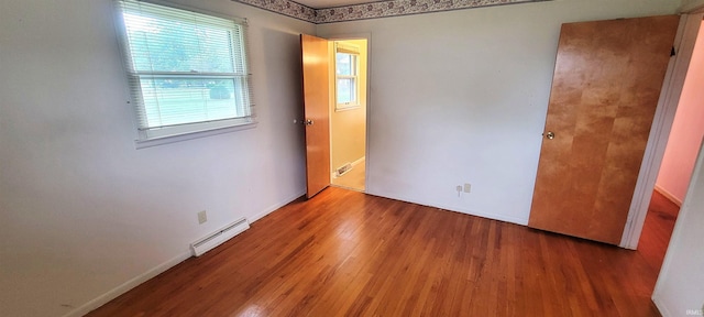 113 N Beechwood St, Warsaw, IN 46582 - unfurnished room with a baseboard heating unit and wood finished floors