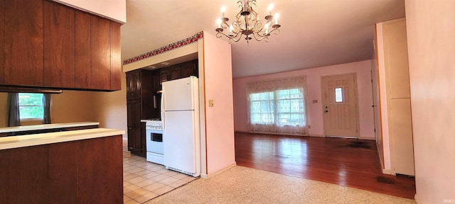 113 N Beechwood St, Warsaw, IN 46582 - kitchen with white appliances, a chandelier, light countertops, and light floors