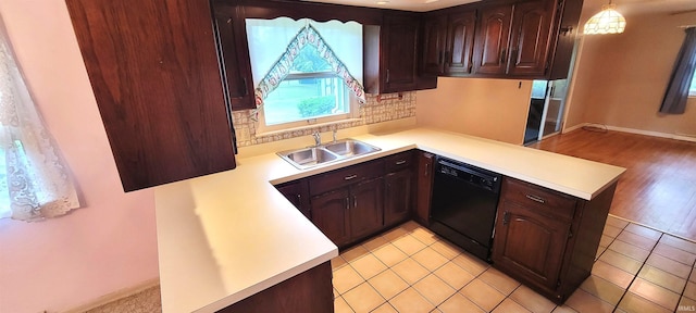 113 N Beechwood St, Warsaw, IN 46582 - kitchen with dishwasher, a peninsula, light countertops, tasteful backsplash, and dark brown cabinets