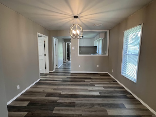 723 E N St, Kokomo, IN 46901 - unfurnished dining area with a chandelier and dark wood-style floors