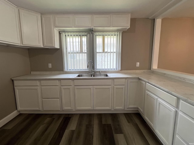 723 E N St, Kokomo, IN 46901 - kitchen with white cabinets, light countertops, and dark wood-style flooring