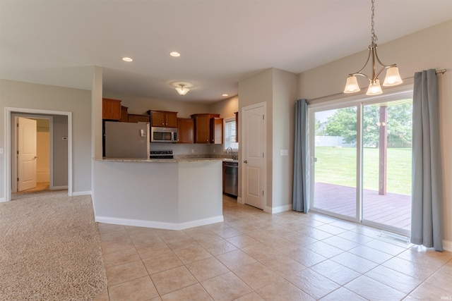 7655 Briar Ct, Newburgh, IN 47630 - kitchen with stainless steel appliances, brown cabinetry, recessed lighting, decorative light fixtures, and light stone counters