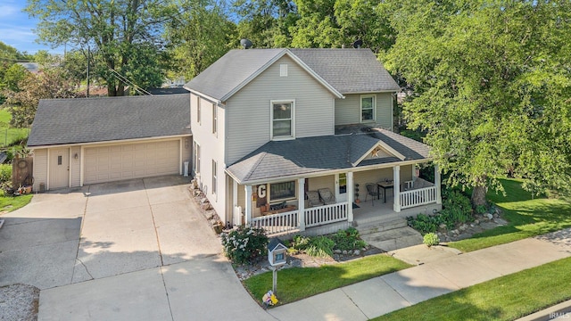 17612 State Road 37, Harlan, IN 46743 - view of front facade featuring a porch, a garage, a front lawn, and a shingled roof