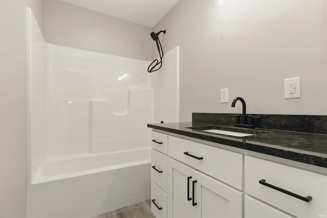 1724 28th St, Bedford, IN 47421 - full bathroom with vanity, shower / bath combination, and wood finished floors