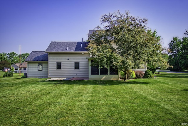 2560 E Maple Dr, Bluffton, IN 46714 - rear view of property featuring a lawn, a shingled roof, and a patio