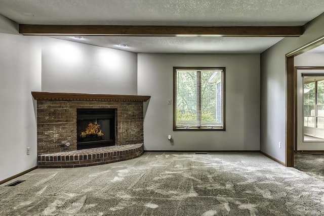 2560 E Maple Dr, Bluffton, IN 46714 - unfurnished living room with beamed ceiling, carpet floors, a fireplace, and a textured ceiling