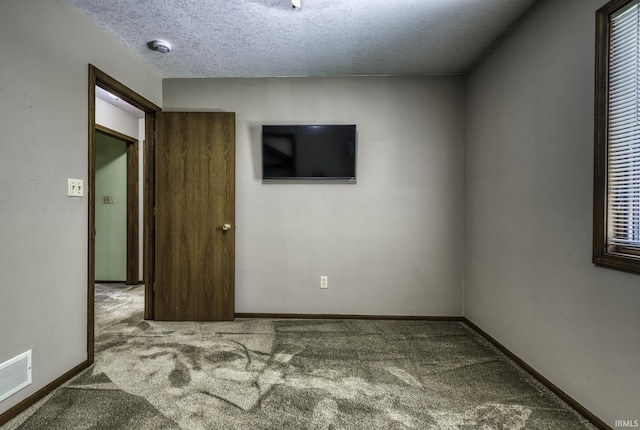 2560 E Maple Dr, Bluffton, IN 46714 - carpeted spare room with a textured ceiling and baseboards