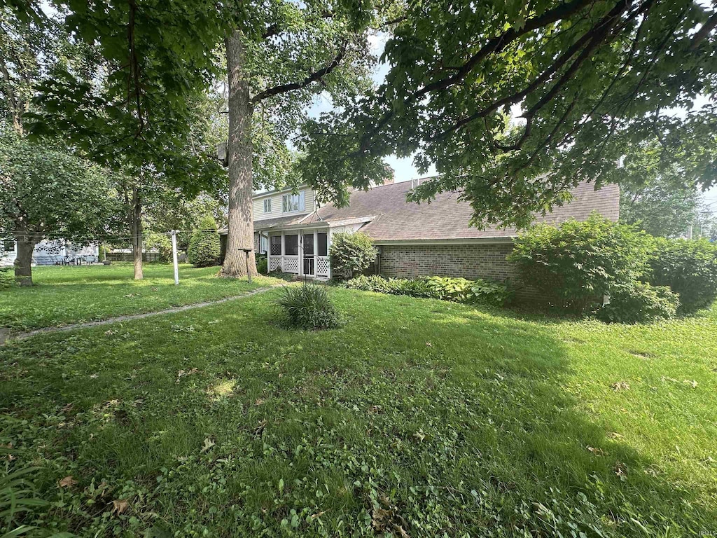 220 W S St, Tipton, IN 46072 - view of front of home with a front yard and brick siding