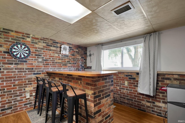 7244 Oaklawn Dr, Newburgh, IN 47630 - indoor dry bar featuring wood finished floors, a drop ceiling, and brick wall