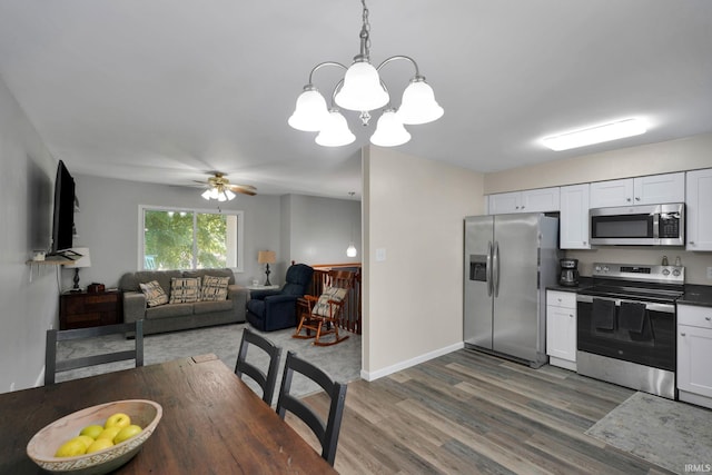 7244 Oaklawn Dr, Newburgh, IN 47630 - dining room with dark wood finished floors, a chandelier, and a ceiling fan