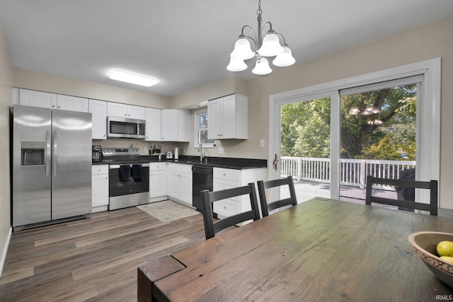 7244 Oaklawn Dr, Newburgh, IN 47630 - kitchen with appliances with stainless steel finishes, dark countertops, a chandelier, and plenty of natural light