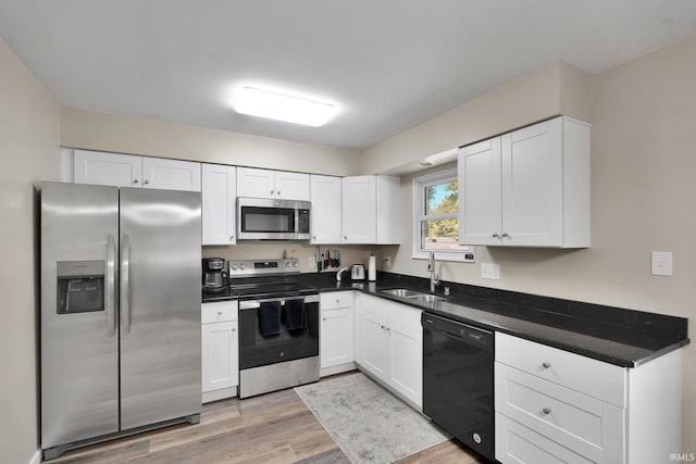 7244 Oaklawn Dr, Newburgh, IN 47630 - kitchen featuring stainless steel appliances, light wood-type flooring, and white cabinetry